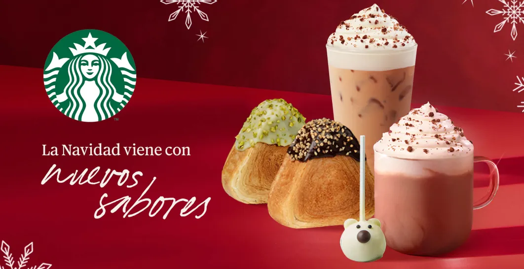 Dos cafés, uno frío y otro caliente, y dos pastries sobre una mesa de madera con copos de nieve alrededor